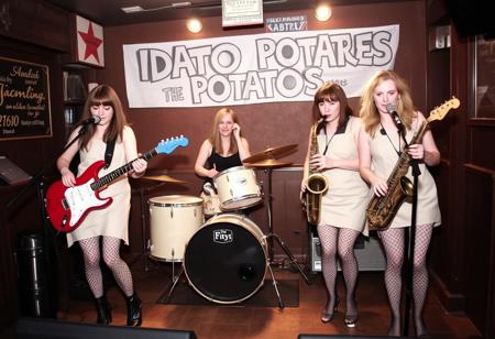 "The Idaho Potatoes", An all female 'New Wave band from Boise Idaho, Aoife on Guitar, Brigid on Drums, E.M. on Keyboards, Gwyneth on Saxophone, all dressed in old potato sacks and fishnet stockings, They are performing on stage in a small smoke filled pub in Birmingham England, somehow a 'producer' had seduced E.M. and left her pregnant-then abandoned them after he took all their money and left them in the middle of a Birmingham street, They hope to make it big in the coming decade (the 1980's), but Gwyneth is doubtful and is thinking about leaving the band,