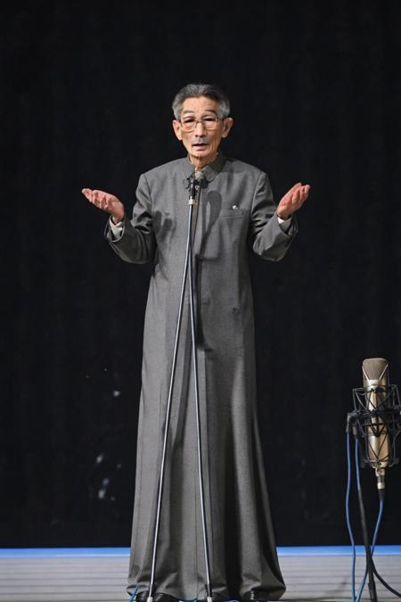 best quality, masterpiece,Grey background,unlined long gown,full body,Vertical microphone,looking at viewer, glasses,old men,<lora:masanli:0.8>