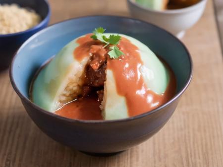 A bowl of translucent Bahuana, a traditional Asian dish, cut open to reveal a rich meat filling. The Bahuana is soft and chewy, and its skin is so transparent that the filling inside is clearly visible. It is generously topped with thick tomato sauce and viscous gravy, which add a vibrant color contrast and enhance the visual appeal. The bowl is placed on a rustic wooden table, with chopsticks resting on the side. The scene should be as realistic as a high-resolution photograph, with warm and inviting lighting that highlights the appetizing qualities of the dish and the cozy atmosphere of the setting,<lora:bahuana:0.75>,bahuana,