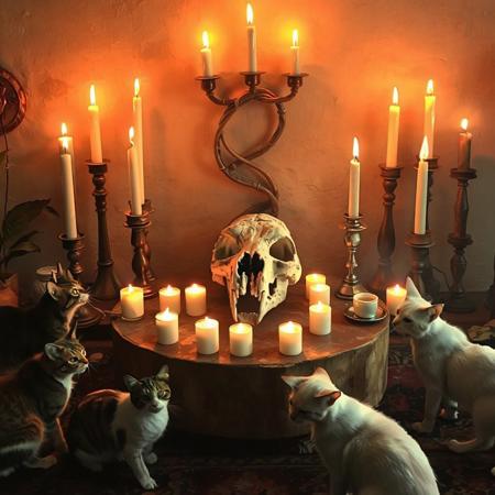 altar for cat worship. many intertwined burning candles on the altar. fossil skull of an ancient mighty cat in the center of the altar. cats walk around the altar