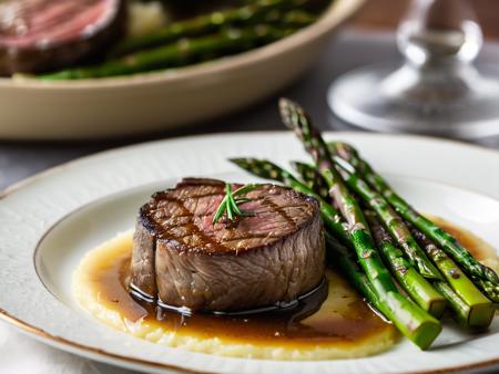 RAW photo, closeup on subject, side view, ground shot, perfect round cut of fillet mignon, well marbled, cooked rare, dark caramelization, nice char, garlic butter on top, au jus, side of mashed potatoes, side of grilled asparagus, all sitting on a white china plate, steam rising from the food, bokeh, shallow depth of field, food photo, 8k, ultra sharp focus, intricate details,  DSLR, volumetric lighting, rim lighting, high quality, film grain, Fujifilm XT