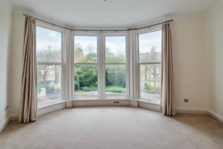 wide angle photo, ovfi, view through window, residential neighbourhood, london, bay windows,  large windows, <lora:buildings view from indoors_epoch_9:0.5>, <lora:add_detail:0.5>, RAW photo, 8k uhd, dslr, soft lighting, high quality, film grain, Fujifilm XT3, lr