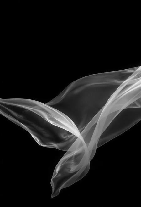 An abstract composition of wind depicted as flowing translucent ribbons slicing through a dark void, stylized in high-contrast black and white with subtle glowing edges. The scene is minimal, with sparse lines and gentle gradients that evoke ethereality, sharp directional lighting creating deep shadows and narrow highlights, cinematic surreal mood, vivid style
