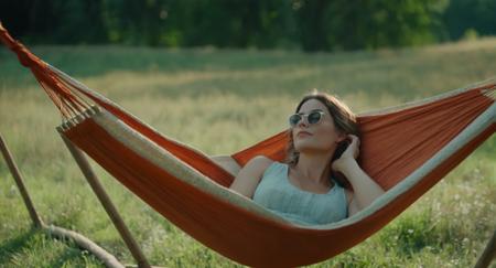 cinematic film still of  <lora:Retro:1> Grainy Cinematic Film stock footage in (arri alexa style) Kodak film print, a woman laying in a hammock retro style, shallow depth of field, vignette, highly detailed, high budget, bokeh, cinemascope, moody, epic, gorgeous, film grain, grainy