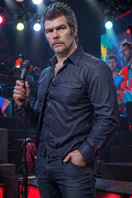 <lora:RhodGilbert:1> rhod gilbert. man with beard standing, on stage, portrait, face, black shirt