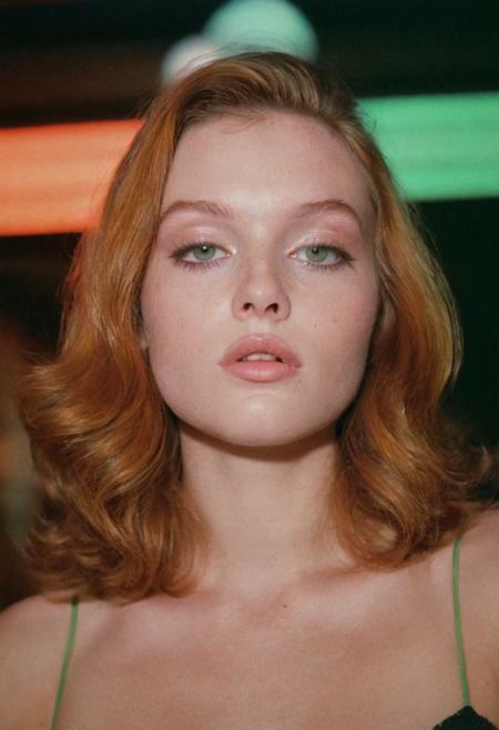 analog film photo ((EuroBabe, 80sPortrait)), ginger, green eyes, makeup, neon lights, (film grain:1.5) . faded film, desaturated, 35mm photo, grainy, vignette, vintage, Kodachrome, Lomography, stained, highly detailed, found footage