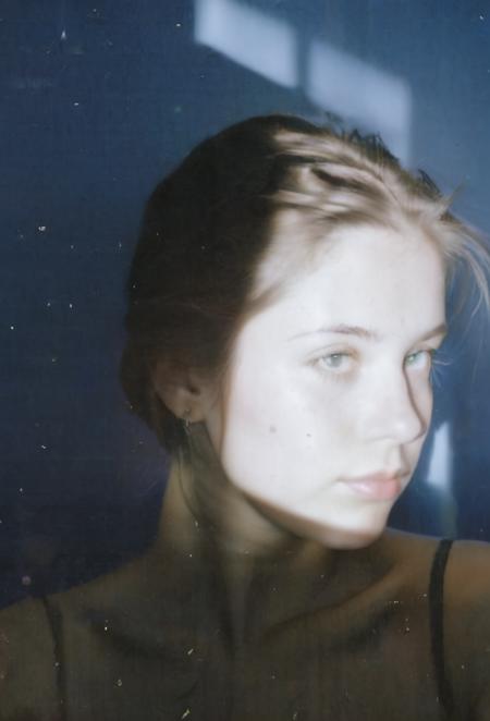 FP100C, Portrait, womans bedroom scene, portrait photo of stylish 21yo Canadian woman, soft facial features, perfect detailed eyes, natural skin, (hard shadows:.81), prismatic light, grainy, shadows, spotlight, sensual, voyuerism <lora:FP100C_frameless:1>