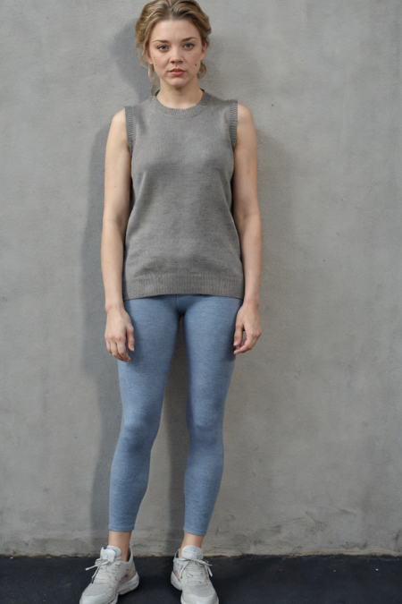 1girl, full body shot, a woman in a sleeveless sweater and leggings standing in an empty room, sneakers, simple cement wall in the backdrop, detailed face, (photorealistic, absurdres, best quality, masterpiece:1.4), (high detailed skin:1.3)
 <lora:nd82_20s_lora_v01:1> nd82, blue eyes