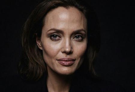 Close-up, (angelina jolie), grim smile, relaxed pose, portrait movie shot, serious, menacing, chiaroscuro style photo, dark background, minimalism, dramatic lighting, professional quality, dull highlights and shadows, natural and   original, laser eyes