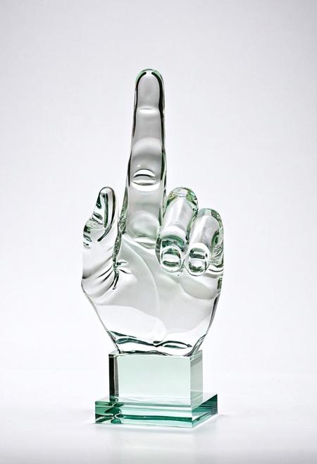A clear glass sculpture showing the middle finger