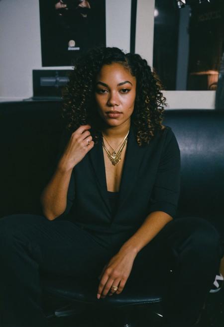 (gritty analog photo:1.2), candid (snapshot:1.2) of a sophisticated and cool 22-year-old biracial female hip-hop artist from Brooklyn sitting in a backstage room getting ready for her show, natural skin texture, realistic skin texture, (skin pores:0.8), (skin oils:0.8), (behind the scenes photography:1.2), documentary style photography, high contrast, deep shadows, hires, highly detailed, (film grain:1.2), the picture conveys effortless coolness, polaroid film photography