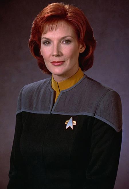 photo of a ((woman)), red hair, wavy, black and grey ds9st uniform, yellow collar, long sleeves, short hair, 
<lora:DS9XLVGRAD3:0.8>