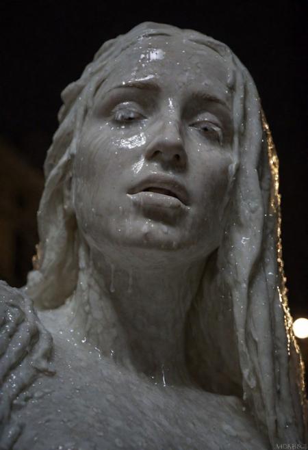 A very detailed masterpiece statue of a goddess, marble pulsating in luscious town square m, night time, parted lips, (marble liquid dripping from face):1.4, in style of Donatello and Michelangelo, detailed textures, bokeh, night lighting, 4k uhd, dslr, soft lighting, high quality, Fujifilm XT3