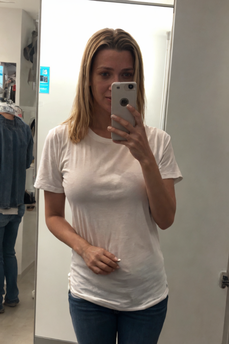 1girl, selfie with an early 2000s vibe, woman holding a flip phone at arm's length, slightly awkward angle, bright flash creating harsh lighting and shadows, low-resolution image quality, visible mirror reflection in the background, wearing casual Y2K fashion like a graphic tee or chunky accessories, capturing the nostalgic and candid feel of the era, detailed face, (photorealistic, absurdres:1.4), (high detailed skin:1.3)
 <lora:lh69_us_lora_v02:1> lh69, blonde hair
