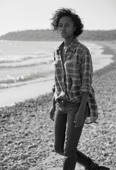 full body shot. flat-chested  Ethiopian woman, face like [Ava Lavinia Gardner::0.6]. magical grey eyes and flowing black hair, short messy black hairstyle. eyes catchlights. (awesome beauty).  (natural tiny saggy breasts). Photograph by Vivian Maier. surprise facial expression, ashamed, textured skin, goosebumps, (wide-open:1.4) flannel shirt with cropped skinny jeans and combat boots, sensually dynamic pose, peaceful walkway seashore beach, bokeh, sharp focus on subject, natural light form early spring at midday, sun hits her face. (visible round small bare breasts). (bumped nipples:1.3). nipslip . shot on ilford HP5 Plus