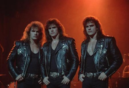 (80sPortrait), indoors, heavy metal band, stage, vintage retro, spotlights, 80s hair