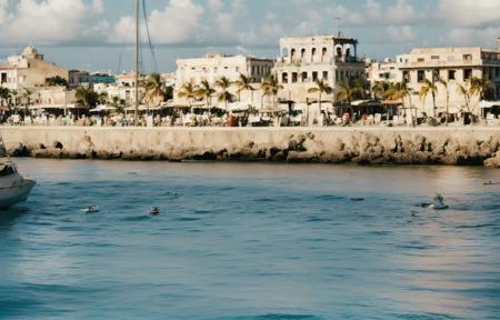 amateur photo of (Havanna:1.2), Cuba in the (1970ties:1.3), (coast and sea:0.9), colorful buildings, panorama, palm trees, (old city:1.1), sea, cliffs, beach, azure, bay, sunny, no clouds, cinematic lighting, golden hour, god rays, 8K, (highly detailed:1.5), (ultra-realistic:1.5), Kodak,  (ag200:1.2) (film grain) <lora:Analog Style Agfa:0.88>