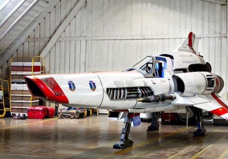 colonialvpr fighter jet<lora:Viperpilotsuitv07:1> ,in spaceship hangar bay,RAW photo, 8k uhd, dslr, soft lighting, high quality, film grain, higly detailed face,Fujifilm XT3