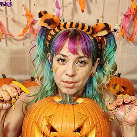 coveredwithpumpkinslime multicolored pigtails with tiger headband and hands up is covered in orange oil is covered in oil is covered in orange slime is covered in slime with lit jack-o-lantern at night,  <lora:CarvingPumpkins:1>