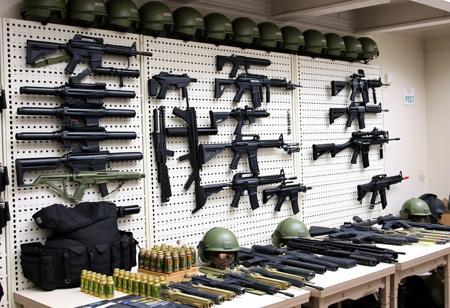 Weapon racks, Modern weapons, Guns, military equipment, Indoors, Weapons on tables, military setting, Bullet proof vests, grenades, helmets,