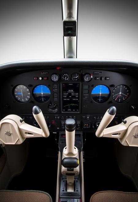 A beautifully composed professional photograph of a Cessna 172 instrument panel after a full Garmin upgrade, GTN 750, G5