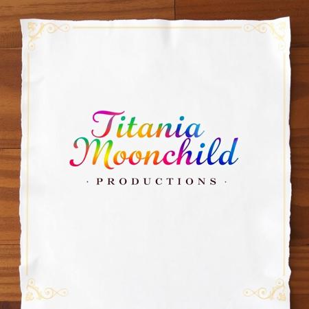 piece of white cotton paper with a gold filigree print border around the margins, centered at the top of the paper in a calligraphy script font are the words "Titania Moonchild Productions" on top of a rainbow gradient letterhead