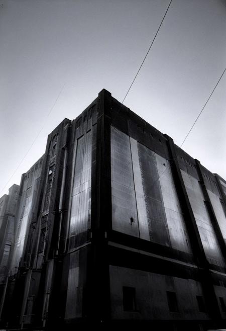 detailxl, 80sc1nemat1c5tyle, creamy bokeh, monochrome, BREAK, never ending line of buildings far away to the horizon, oppression