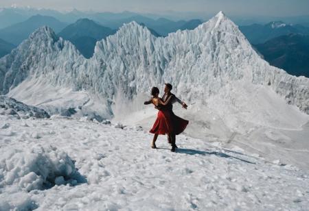 leica m3, 35mm Voigtlander lens, Portra 160/400, photo of a pair flamenco dancer practicing at Himalaya ice mountain peak top. drone camera view from distance,high contrast, natural  sunlight, National Geographic cover