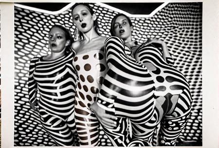 An award winning genre defining documentary candid photograph of ,three female dancers of the experimental conceptual performance artists, they're wearing a wild expressive skin tight jumpsuit by Pucci, at a wild drunken party, the room is filled with onlookers to their bizarre performance,  Brazilian Tropicalia retrofuturism,  Leica M3, 50mm lens, candid photography <lora:CultFlix-SD15:2> strong drop shadows, depth of field stereoscopic effect,  <lora:cursed images:1>