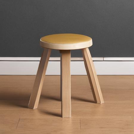 artek, Solid birch, Solid birch, Birch plywood, Birch veneer, High-pressure laminate, Linoleum, Fabric upholstery and PU foam padding, Leather upholstery and PU foam padding, Leather upholstery,a small wooden stool with a curved wooden seat on a white background,