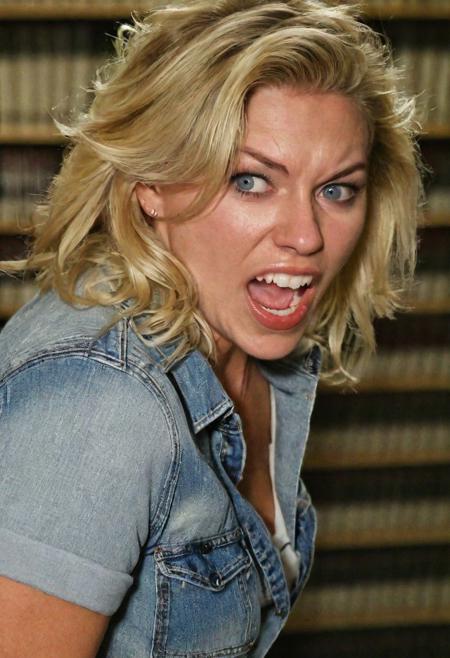 A casual  (((close up  photo))), of a ((((((clothed))), (((SFW)))))) blond , (31 yo woman), (blue  eyes), tousled hair , (chubby  body), jumping , shouting angrily , (library), at night, snapped on (point-and-shoot , 35 mm lens equivalent, f5.6 , ISO 800 ), (((sharp focus, detailed body, perfect eyes, perfect teeth, perfect hands, perfect feet)))