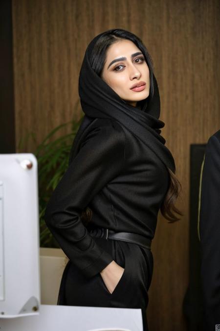 A 35yo palistian Iranian woman, high cheek bones, long face, sultry gaze, no smile, black roosari, doggystyle, from side, 1girl, 1boy, sex from behind, in the office