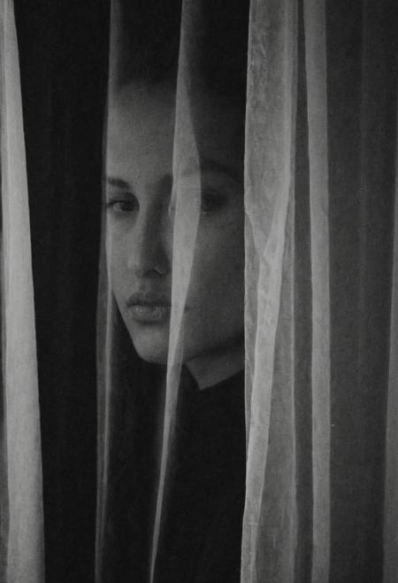 low quality image, noise, CLOSEUP hafl side PORTRAIT of women, BLACK AND WHITE IMAGE. black and white image.
transparent curtain,dark, night, street light on face, perfect composition, surreal, looking at viewer.
