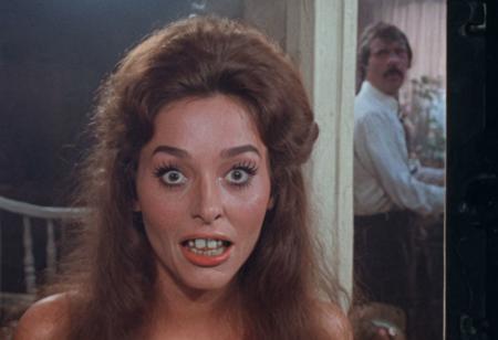 screengrab of original VHS movie | TV show from early 70's | portrait shot, Lizzy Karla with funny face | fantasy atmosphere | grainy, low quality