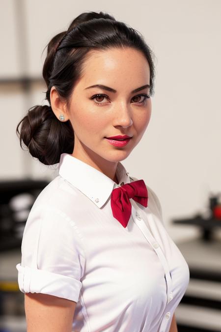 photo of a woman, oliviam,((hair up , hair in bun):1.1) ((bowtie, white shirt, shorts):1.2), ((closeup, portrait)),((garage, tools, workbench):1.2),((red lipstick, eyeliner, eye shadow, blush)), ((best quality, masterpiece, extreme details, high resolution):1.2),((detailed eyes, beautiful eyes, detailed face, beautiful face):1.2)