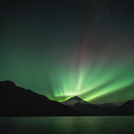 cinematic film still of  <lora:volumetric lighting:1> volumetric lighting style
a mountain with a green aurora bore in the sky,outdoors,sky,water,no humans,night,star (sky),night sky,scenery,starry sky,rock,mountain,green theme,landscape,aurora , volumetric lighting, haze light, fog light, beam light, shallow depth of field, vignette, highly detailed, high budget, bokeh, cinemascope, moody, epic, gorgeous, film grain, grainy