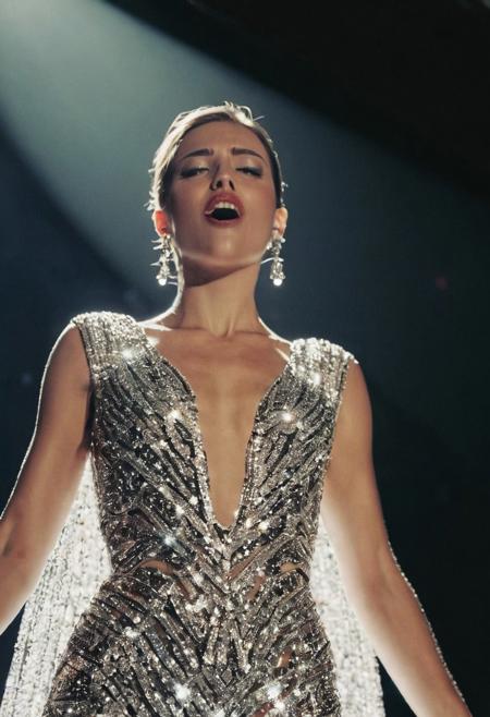 A female model, wearing a flashy dress that shines like diamonds, on a stage, singing, studio lighting, low angle view, closeup, detailed, analog film grain, detailed, DSLR
