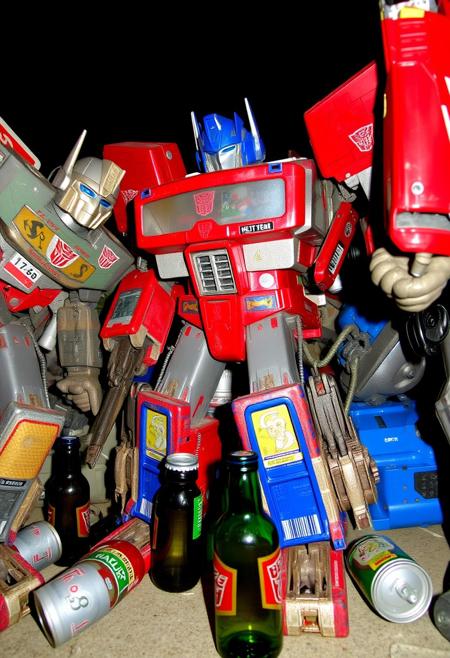 Drunk Transformers, very very drunk, empty beer cans and bottles, wasted.