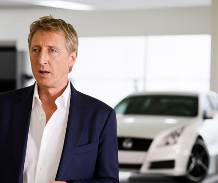 Johnnylawrence person <lora:JohnnyLawrence-Lora:.8> working as the manger of the best car dealership in Los Angeles. Suit Tie, car showroom.