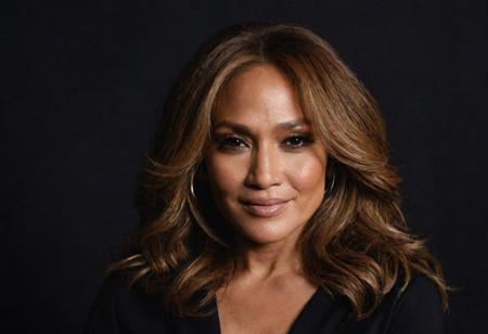 Close-up, (jennifer lopez), grim smile, relaxed pose, portrait movie shot, serious, menacing, chiaroscuro style photo, dark background, minimalism, dramatic lighting, professional quality, dull highlights and shadows, natural and   original,