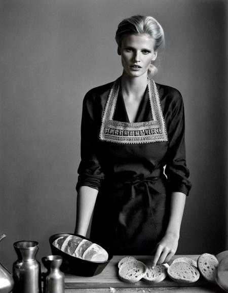 Iran, <lora:LaraStone:1> Lara Stone, a dutch model, 23 year old, posing baking a bread, decently clothed, professional lighting, year 1943 styling, professionally color graded Kodak Tri-X Black and white film, fashion shoot, tack sharp