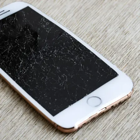  old white iphone with broken screen