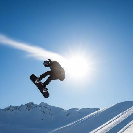 man doing a snowboard stunt, background a sunny blue sky