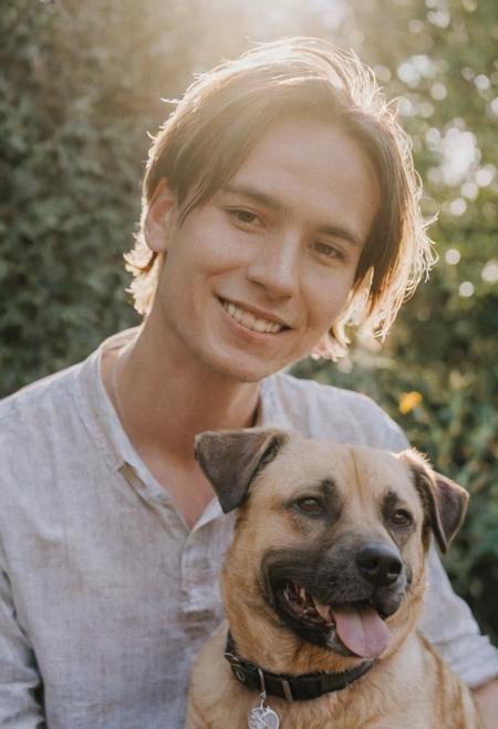 cinematic film still fashion photography portrait of 1man with cute dog as companion, headshot, sunlight , Fine Art & Beauty Photography – ,,light diffraction in frame, dreamy,hazy look.  Helios 44-2 lens mounted on a Praktica MTL 5B Helios 44M-4 lens, 58mm f/2,   in a garden. authentic happy smile