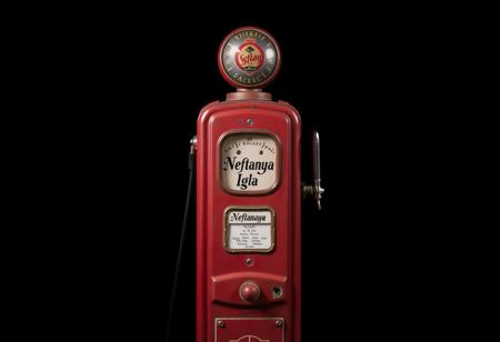 vintage old-school oil pump, black background, inscription on the machine "Neftanaya Igla"