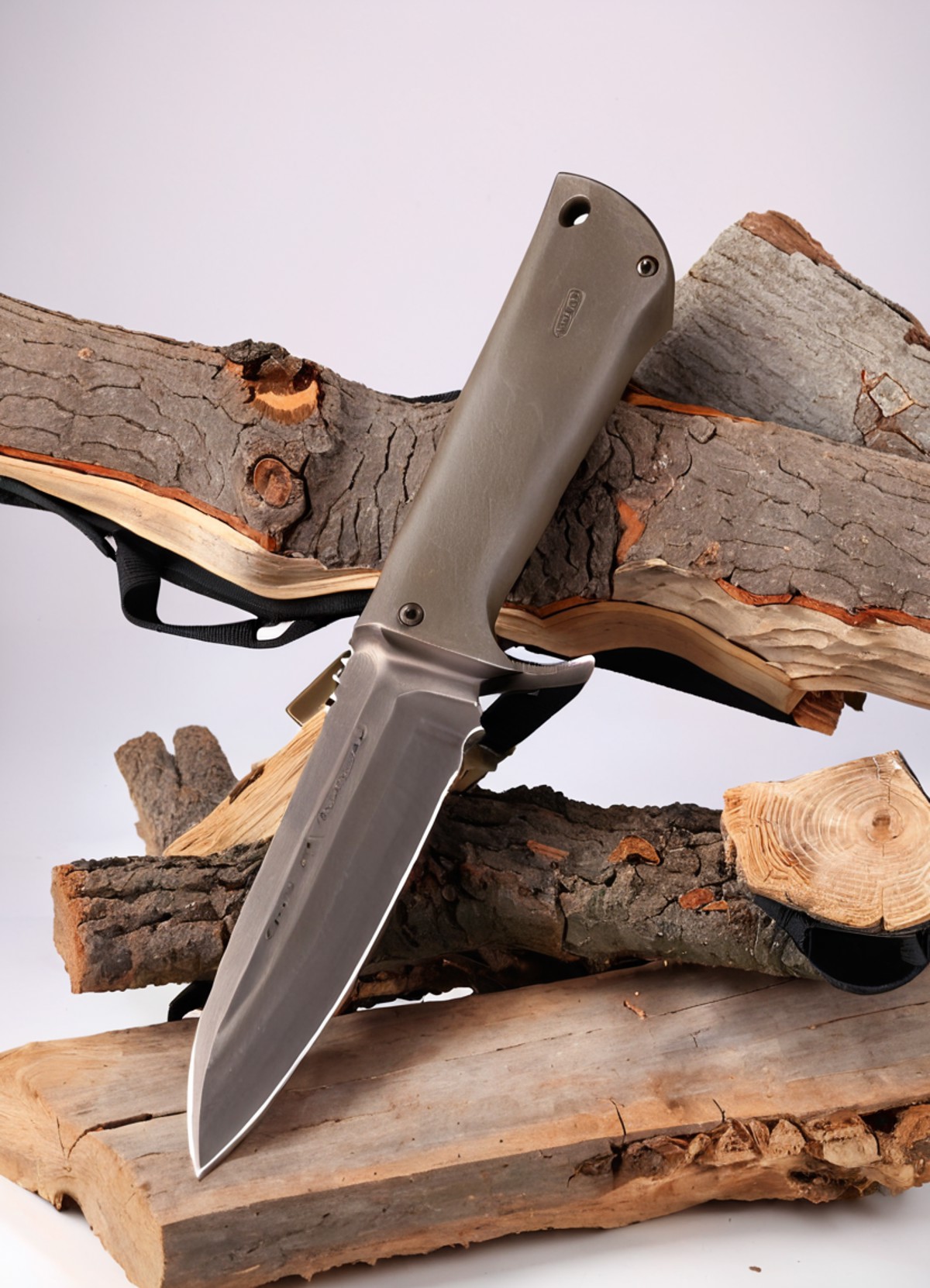 Real estate photography style <lora:FF-Knives-XL-Cr2-v0163:1> a knife sitting on top of a piece of wood next to a piece of...