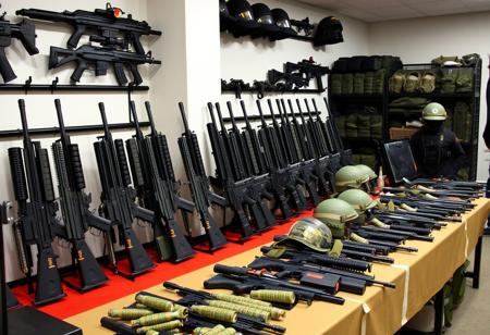Weapon racks, Modern weapons, Guns, military equipment, Indoors, Weapons on tables, military setting, Bullet proof vests, grenades, helmets,