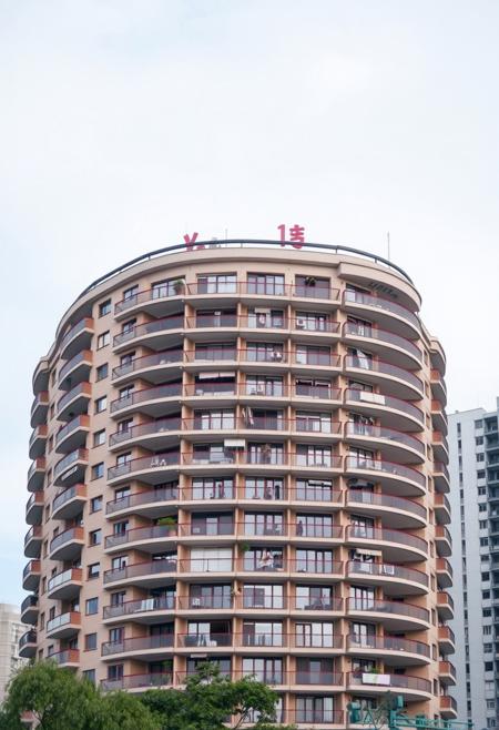 A Chinese apartment residential building with 20 floors and a concave convex structure with balconies on the exterior