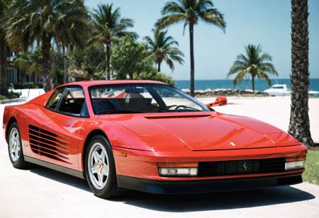 analog film photo (Sportscar gleaming red Ferrari Testarossa, front side view, outdoors), palm trees, seaside, sunny, (stylish, film grain:1.3) . faded film, desaturated, 35mm photo, grainy, vignette, vintage, Kodachrome, Lomography, stained, highly detailed, found footage