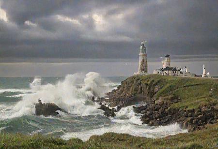 Rough sea, 
huge waves crashing on rocks, 
green and white lighthouse standing on grassy headland in dramatic evening light, 
scattered cumulus nimbus with lightning
